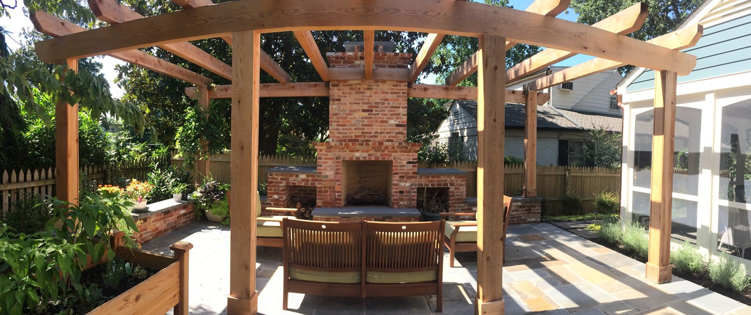 a patio with a fire place and a grill