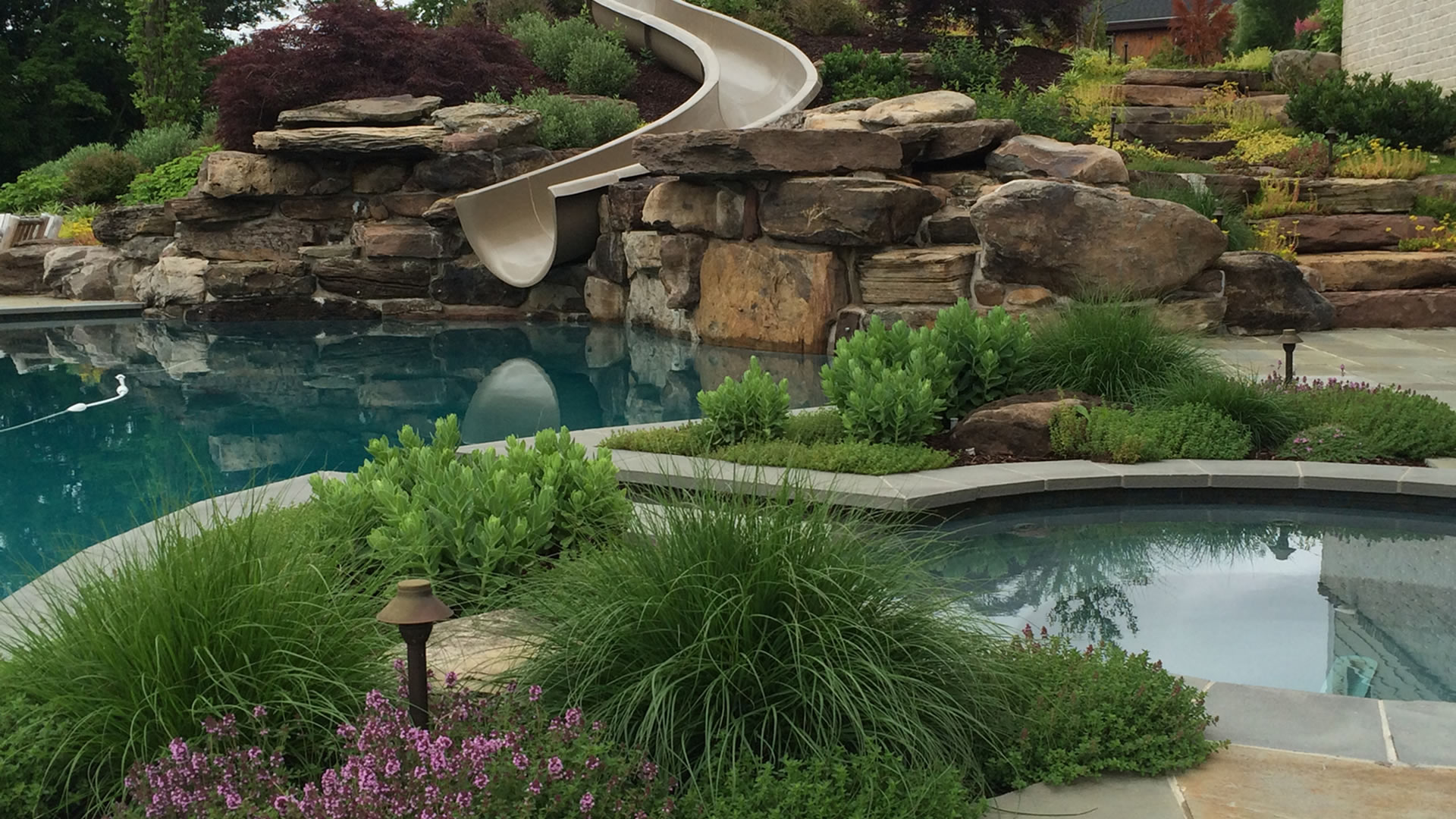 a pool with a slide in the middle of it