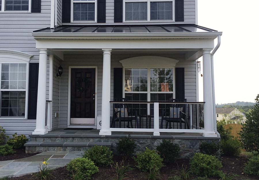 A veranda attached to the front of a home 