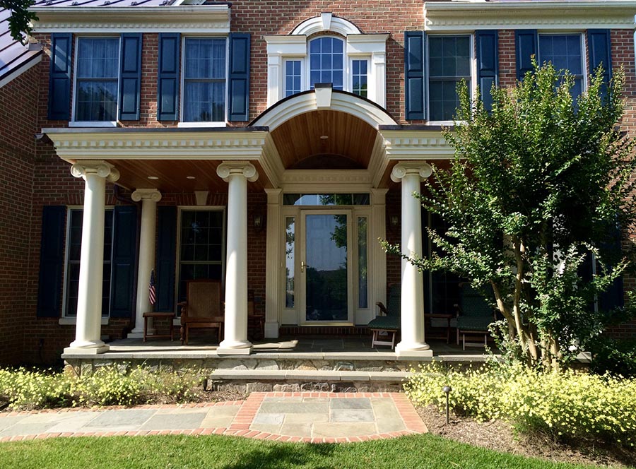 A newly-renovated front porch with white greek columns