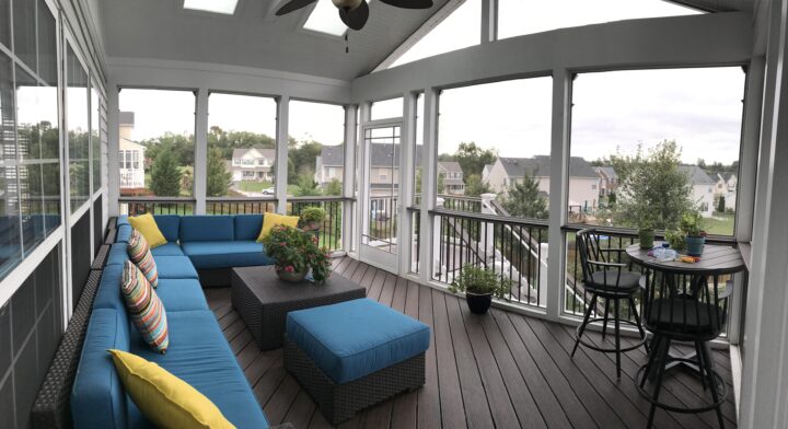 A screened-in porch with a blue couch