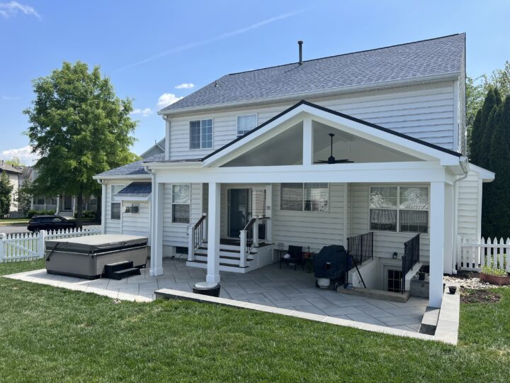 A covered porch attached to the back of a house