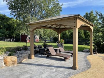 A freestanding pavilion kit with a relaxed lounge area.