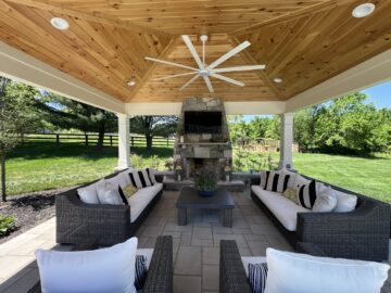 A custom pavilon with a fireplace and a vaulted wood ceiling.