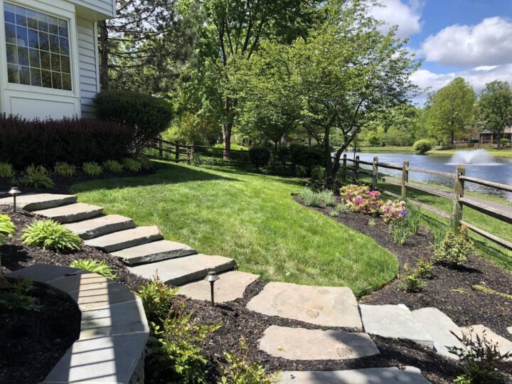 Quarried stepping stones leading down from a house into their garden.