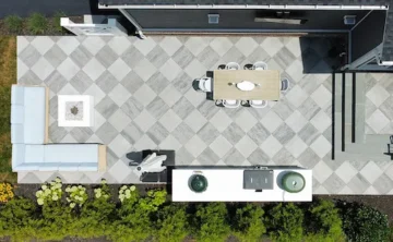 Checkered patio with outdoor kitchen, dining area, and couch
